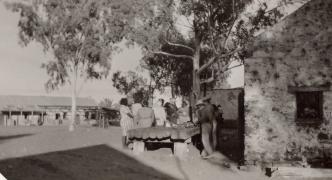 The mess house ration store is the building on the left background